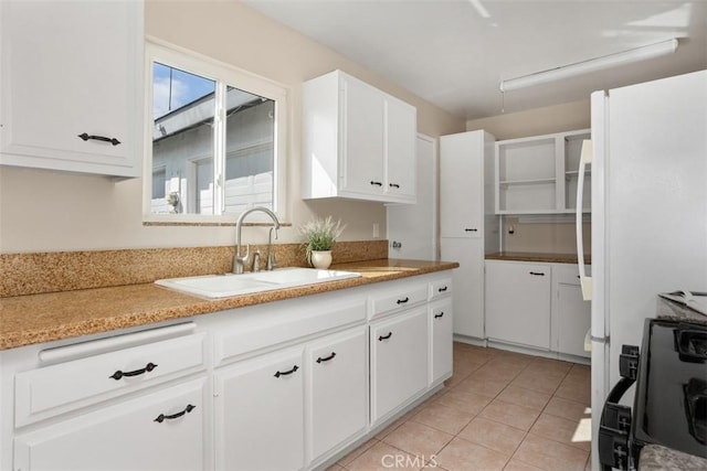 3746 Balboa Dr, Oceanside, CA 92056 - kitchen with white cabinetry, light tile patterned floors, light countertops, and stove