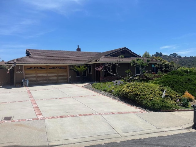 4906 Via Hinton, Carlsbad, CA 92008 - single story home with a garage, a tile roof, concrete driveway, and a chimney