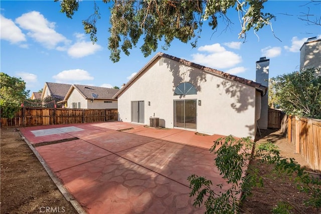 36829 Burroughs Way, Palmdale, CA 93552 - back of house with a chimney, stucco siding, a fenced backyard, and a patio
