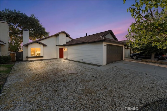 36829 Burroughs Way, Palmdale, CA 93552 - view of front of house with concrete driveway, an attached garage, a tiled roof, and a chimney