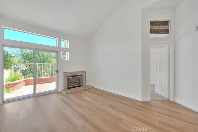 2914 Crape Myrtle Cir, Chino Hills, CA 91709 - unfurnished living room with light wood-style floors, a glass covered fireplace, and high vaulted ceiling