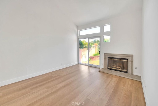 2914 Crape Myrtle Cir, Chino Hills, CA 91709 - unfurnished living room featuring light wood-style flooring and a glass covered fireplace