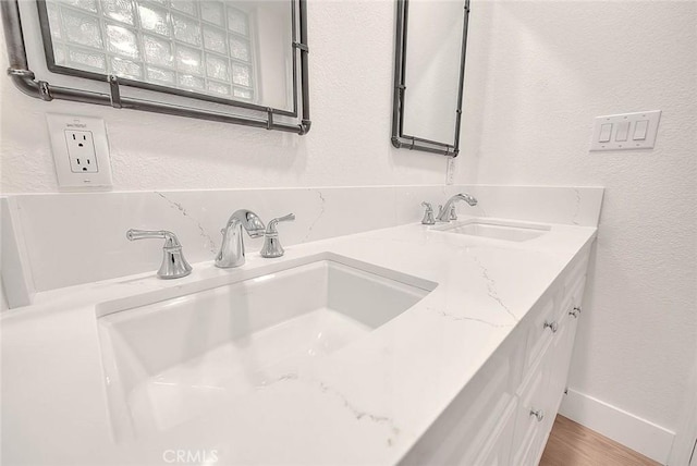 2914 Crape Myrtle Cir, Chino Hills, CA 91709 - full bathroom featuring double vanity, wood finished floors, a textured wall, and decorative backsplash