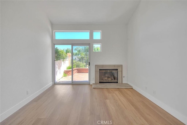 2914 Crape Myrtle Cir, Chino Hills, CA 91709 - unfurnished living room with a glass covered fireplace and wood finished floors