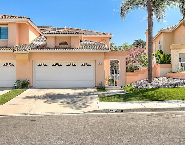 2914 Crape Myrtle Cir, Chino Hills, CA 91709 - mediterranean / spanish-style house featuring a tiled roof, driveway, a garage, and stucco siding