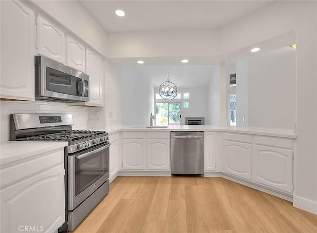 2914 Crape Myrtle Cir, Chino Hills, CA 91709 - kitchen with stainless steel appliances, light wood-type flooring, light countertops, recessed lighting, and white cabinetry