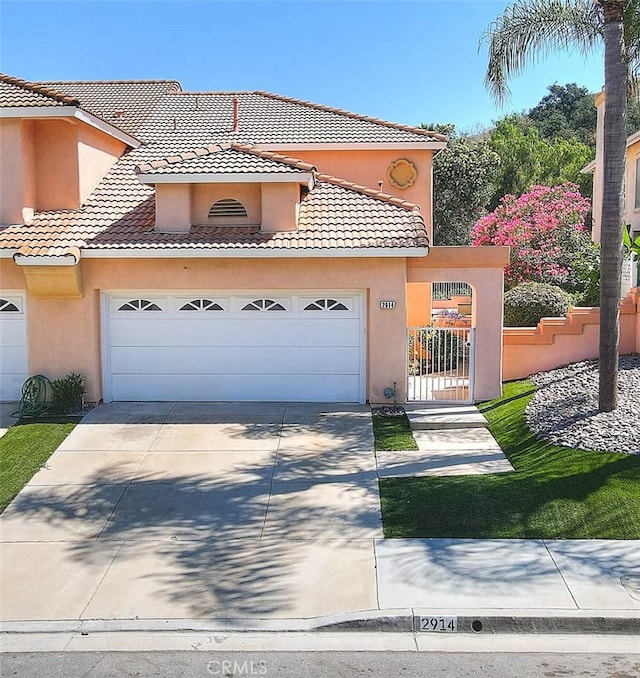 2914 Crape Myrtle Cir, Chino Hills, CA 91709 - mediterranean / spanish-style house with a garage, a tiled roof, stucco siding, and driveway