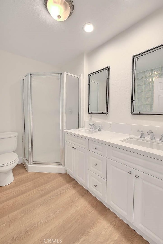 2914 Crape Myrtle Cir, Chino Hills, CA 91709 - bathroom featuring double vanity, a shower stall, wood finished floors, and recessed lighting