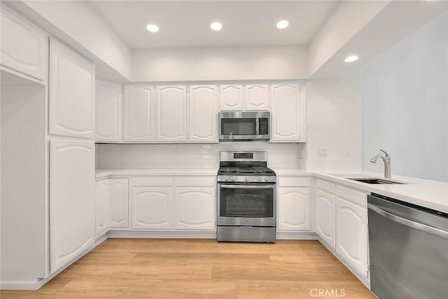 2914 Crape Myrtle Cir, Chino Hills, CA 91709 - kitchen featuring appliances with stainless steel finishes, white cabinetry, light countertops, recessed lighting, and decorative backsplash