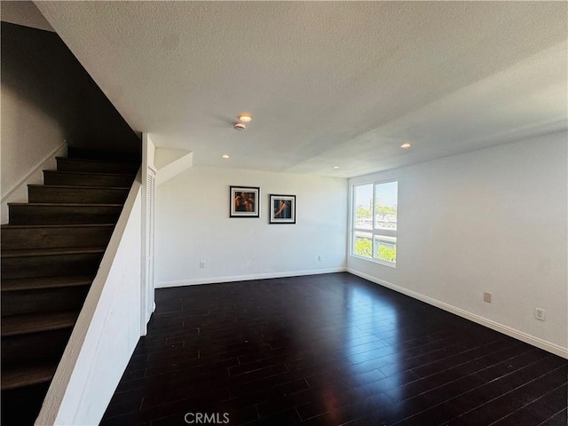6155 Reseda Unit 4, Tarzana, CA 91335 - unfurnished living room featuring dark wood finished floors, a textured ceiling, stairway, and recessed lighting