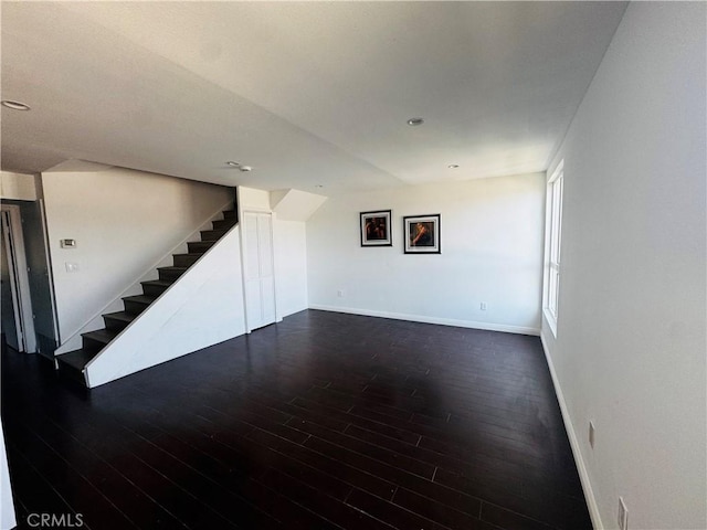 6155 Reseda Unit 4, Tarzana, CA 91335 - unfurnished living room featuring dark wood-type flooring and stairway