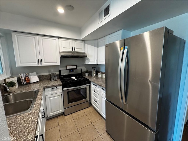 6155 Reseda Unit 4, Tarzana, CA 91335 - kitchen with stainless steel appliances, under cabinet range hood, white cabinets, and light tile patterned floors
