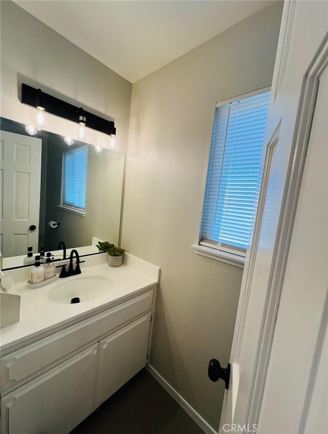 13330 Tamarisk Rd, Victorville, CA 92395 - bathroom with vanity and baseboards