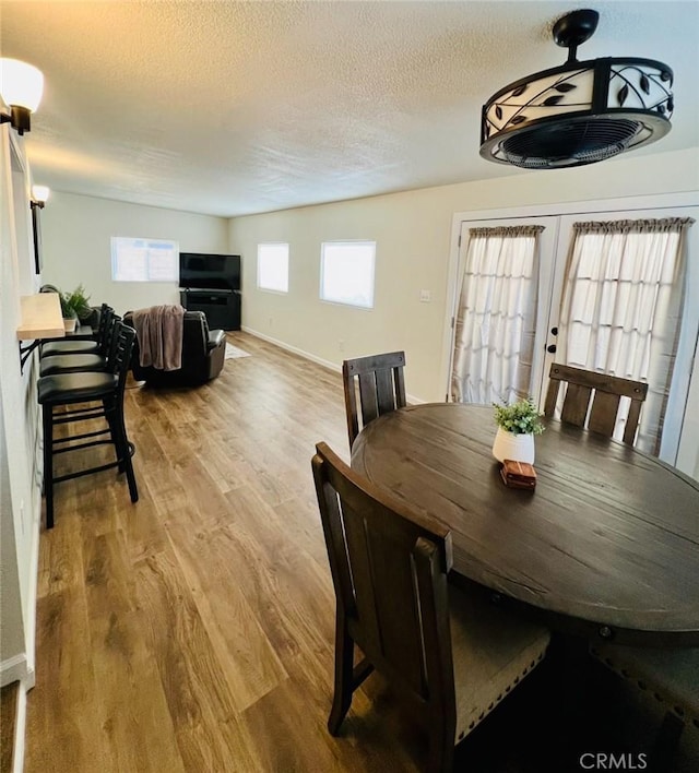 13330 Tamarisk Rd, Victorville, CA 92395 - dining space featuring wood finished floors and a textured ceiling