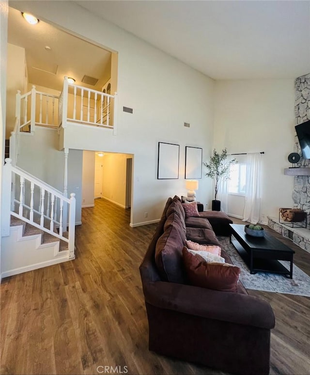 13330 Tamarisk Rd, Victorville, CA 92395 - living room with wood finished floors, a high ceiling, and stairway