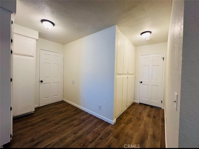 13330 Tamarisk Rd, Victorville, CA 92395 - corridor with a textured ceiling and dark wood-type flooring
