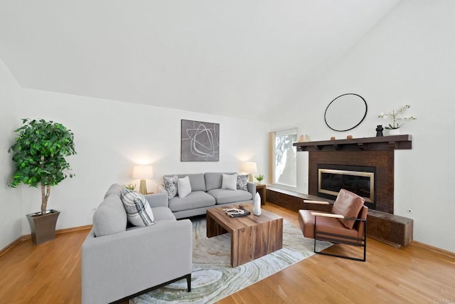 4205 Caminito Pintoresco, San Diego, CA 92108 - living area with light wood-style floors, vaulted ceiling, and a fireplace