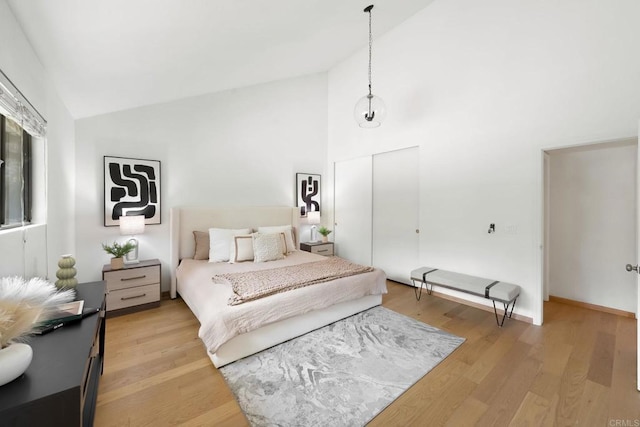 4205 Caminito Pintoresco, San Diego, CA 92108 - bedroom featuring light wood finished floors, a closet, and high vaulted ceiling