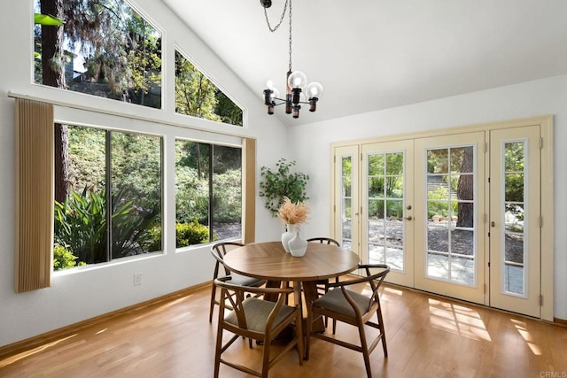 4205 Caminito Pintoresco, San Diego, CA 92108 - dining room with french doors, plenty of natural light, wood finished floors, a chandelier, and high vaulted ceiling