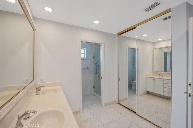 2039 Channelford Rd, Westlake Village, CA 91361 - bathroom with a stall shower, double vanity, tile patterned floors, and recessed lighting