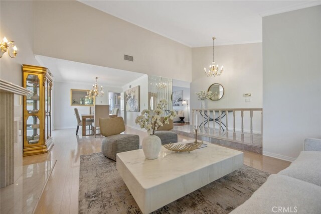 2039 Channelford Rd, Westlake Village, CA 91361 - living area featuring a chandelier, light wood-style floors, crown molding, and a high ceiling