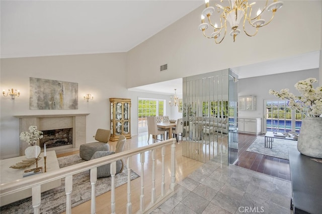 2039 Channelford Rd, Westlake Village, CA 91361 - living area featuring a chandelier, high vaulted ceiling, and a high end fireplace