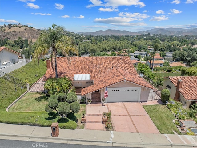 2039 Channelford Rd, Westlake Village, CA 91361 - view of front facade with a gate, a garage, a mountain view, and concrete driveway