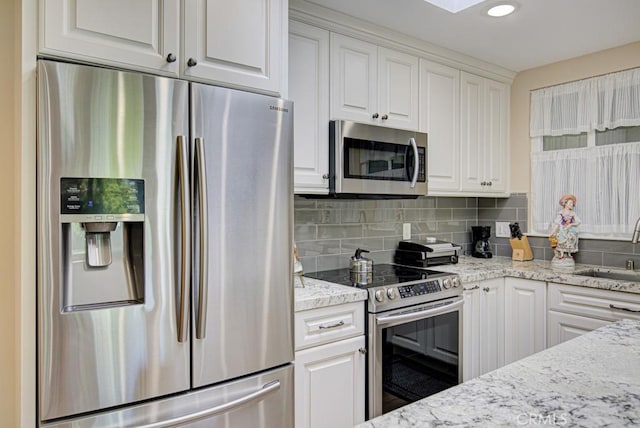 271 Avenida Sevilla Unit P, Laguna Woods, CA 92637 - kitchen with stainless steel appliances, white cabinets, tasteful backsplash, light stone countertops, and recessed lighting