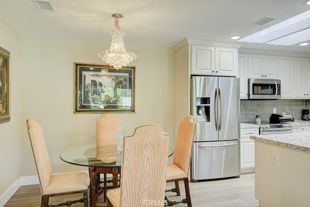 271 Avenida Sevilla Unit P, Laguna Woods, CA 92637 - dining area with light wood-type flooring, a chandelier, and recessed lighting