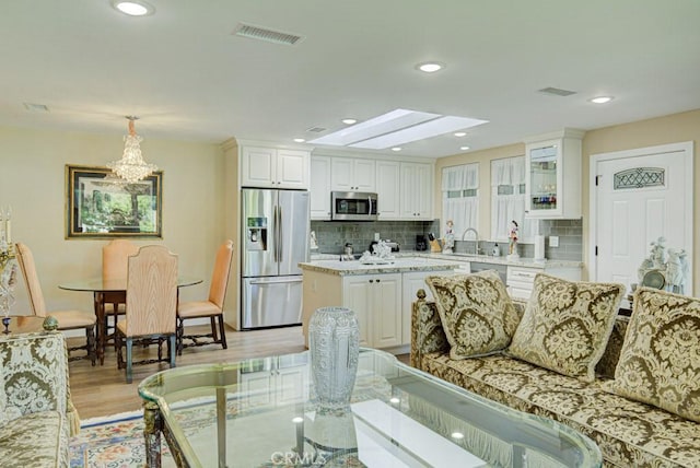 271 Avenida Sevilla Unit P, Laguna Woods, CA 92637 - living area with light wood-style floors, a skylight, a chandelier, and recessed lighting