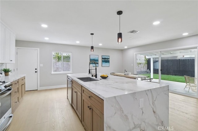 4203 Tolowa St, San Diego, CA 92117 - kitchen with appliances with stainless steel finishes, light wood-style flooring, recessed lighting, decorative light fixtures, and light stone counters