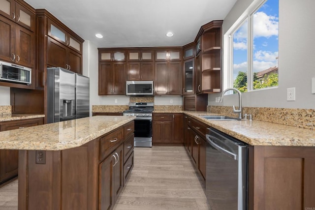 1347 Vallejo Mills St, Chula Vista, CA 91913 - kitchen featuring stainless steel appliances, light wood-style floors, a center island, light stone counters, and recessed lighting