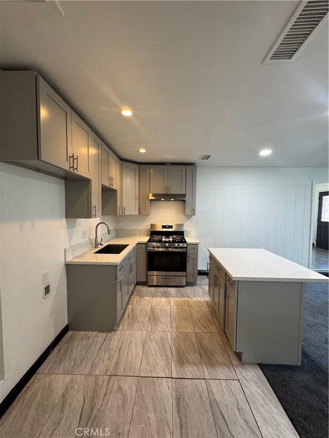 2835 Etiwanda Ave, Rialto, CA 92376 - kitchen featuring stainless steel gas range, gray cabinetry, light countertops, recessed lighting, and under cabinet range hood