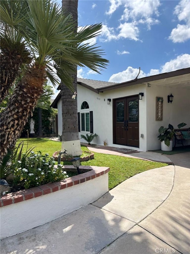 2835 Etiwanda Ave, Rialto, CA 92376 - entrance to property with stucco siding, french doors, and a yard