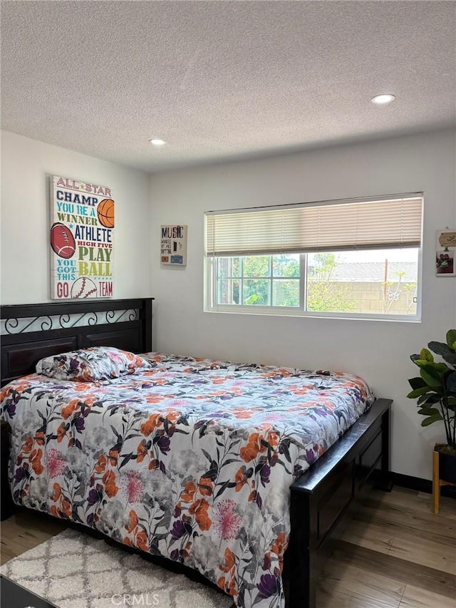 2835 Etiwanda Ave, Rialto, CA 92376 - bedroom featuring a textured ceiling, recessed lighting, and wood finished floors
