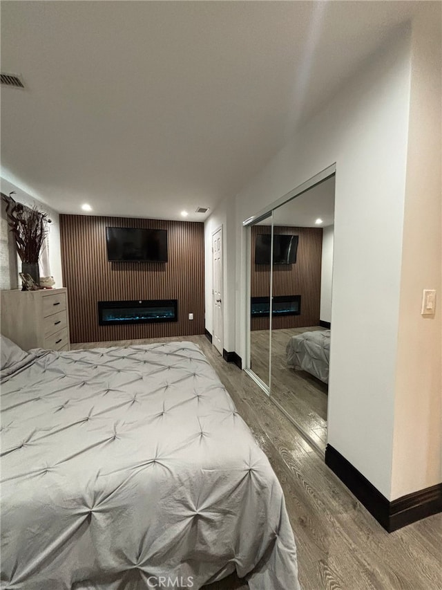 2835 Etiwanda Ave, Rialto, CA 92376 - bedroom with a fireplace, wood finished floors, a closet, and recessed lighting