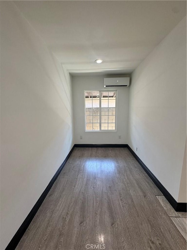 2835 Etiwanda Ave, Rialto, CA 92376 - spare room featuring a wall mounted air conditioner and wood finished floors