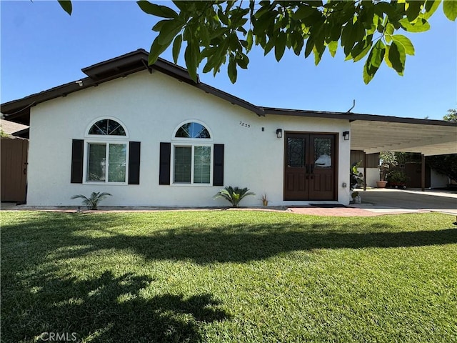 2835 Etiwanda Ave, Rialto, CA 92376 - ranch-style house featuring stucco siding, an attached carport, a front yard, and french doors