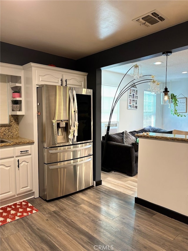 2835 Etiwanda Ave, Rialto, CA 92376 - kitchen featuring stainless steel fridge with ice dispenser, white cabinetry, a chandelier, wood finished floors, and open floor plan