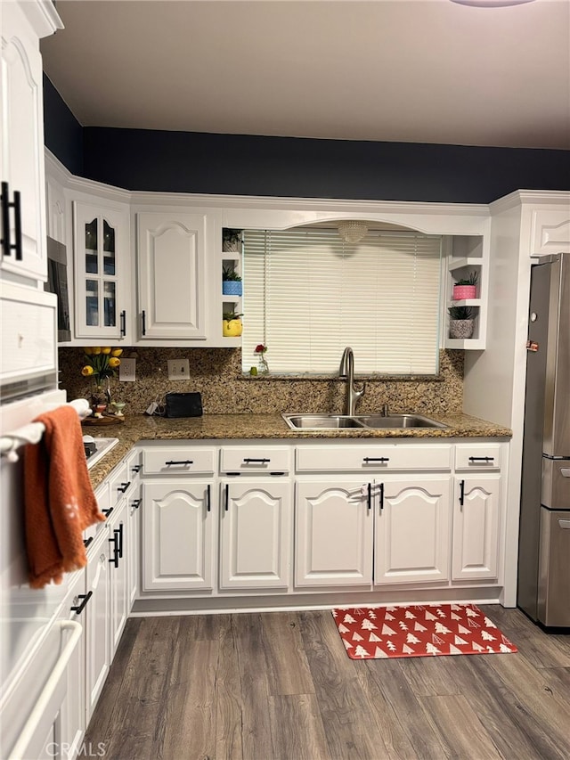 2835 Etiwanda Ave, Rialto, CA 92376 - kitchen featuring freestanding refrigerator, white cabinetry, backsplash, dark wood finished floors, and dark stone countertops