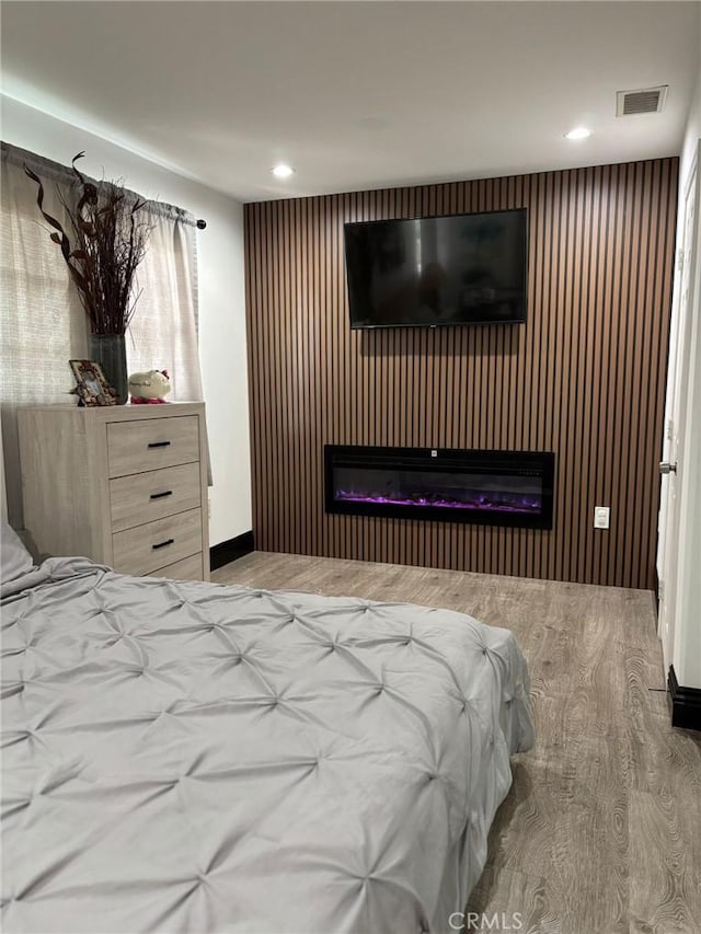 2835 Etiwanda Ave, Rialto, CA 92376 - bedroom with a glass covered fireplace, wood finished floors, and recessed lighting