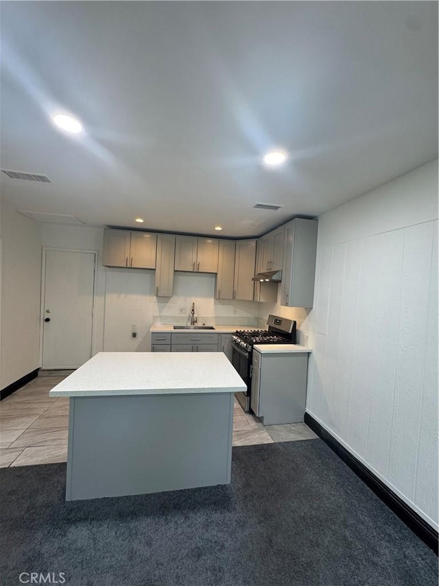 2835 Etiwanda Ave, Rialto, CA 92376 - kitchen with stainless steel gas stove, gray cabinets, a kitchen island, recessed lighting, and light countertops