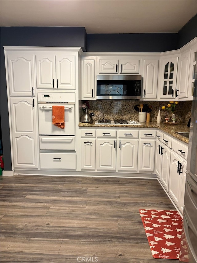2835 Etiwanda Ave, Rialto, CA 92376 - kitchen featuring white appliances, a warming drawer, white cabinets, and decorative backsplash