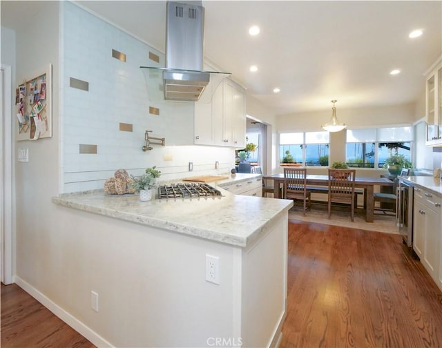 3530 Spearing Ave, San Pedro, CA 90732 - kitchen featuring white cabinetry, island exhaust hood, glass insert cabinets, wood finished floors, and recessed lighting