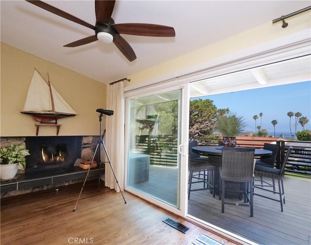 3530 Spearing Ave, San Pedro, CA 90732 - doorway to outside with wood finished floors, a lit fireplace, and a ceiling fan