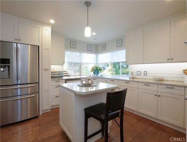 3530 Spearing Ave, San Pedro, CA 90732 - kitchen with stainless steel fridge with ice dispenser, white cabinets, light stone counters, wood finished floors, and recessed lighting