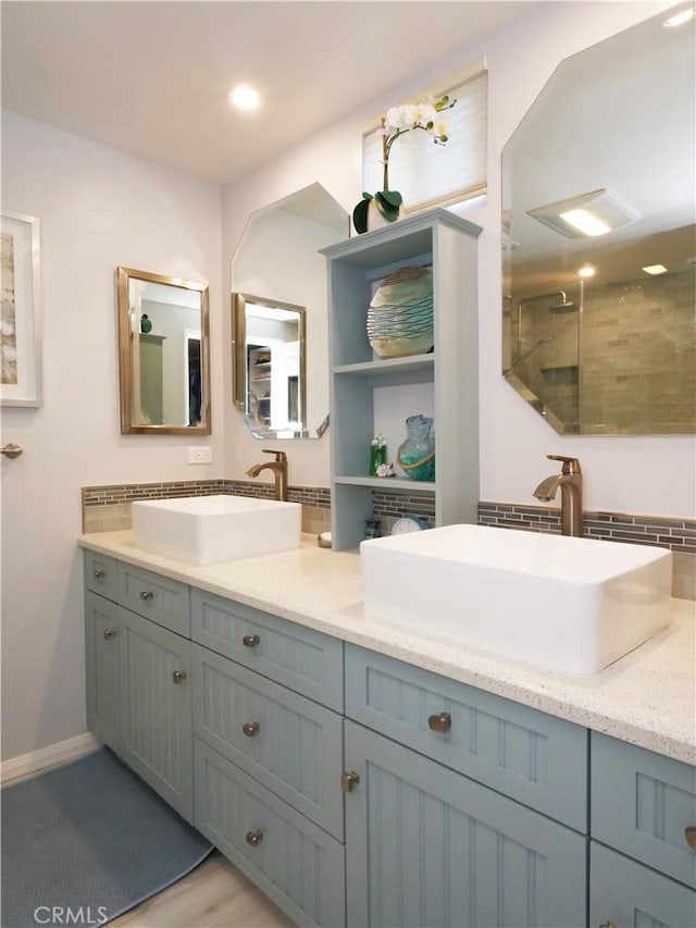 3530 Spearing Ave, San Pedro, CA 90732 - full bathroom with double vanity, a tile shower, tasteful backsplash, and wood finished floors