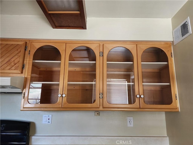 16708 Lawnwood St, La Puente, CA 91744 - detailed view of wall chimney range hood and glass insert cabinets