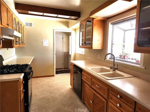 16708 Lawnwood St, La Puente, CA 91744 - kitchen featuring black appliances, under cabinet range hood, brown cabinetry, and light countertops