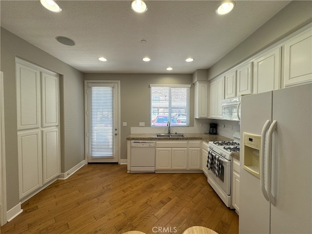 896 Poppyseed Way, Hemet, CA 92545 - kitchen with white appliances, light wood-type flooring, white cabinetry, recessed lighting, and light countertops